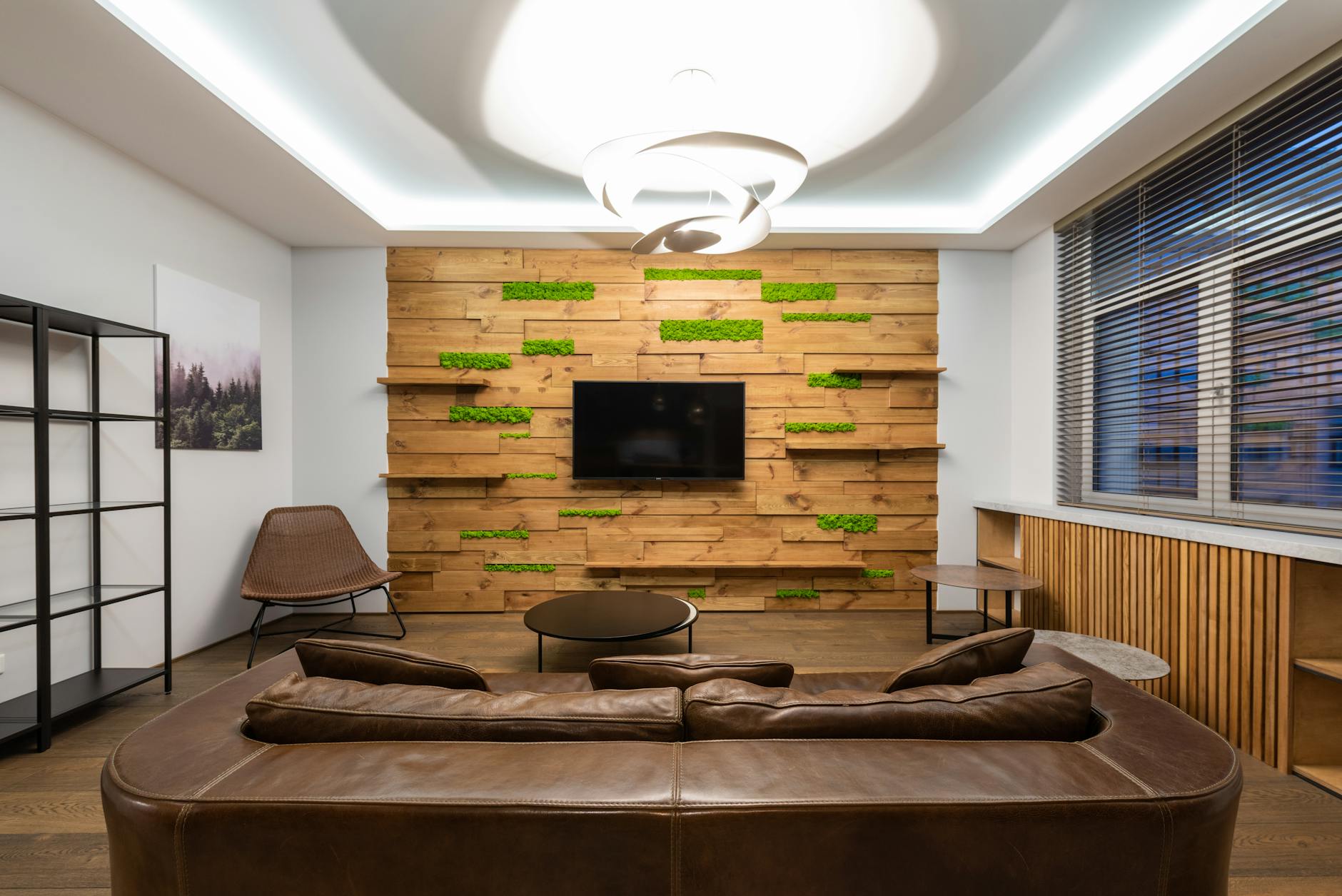 Finished basement living-space reference with sofa, shelving, and modern lighting.