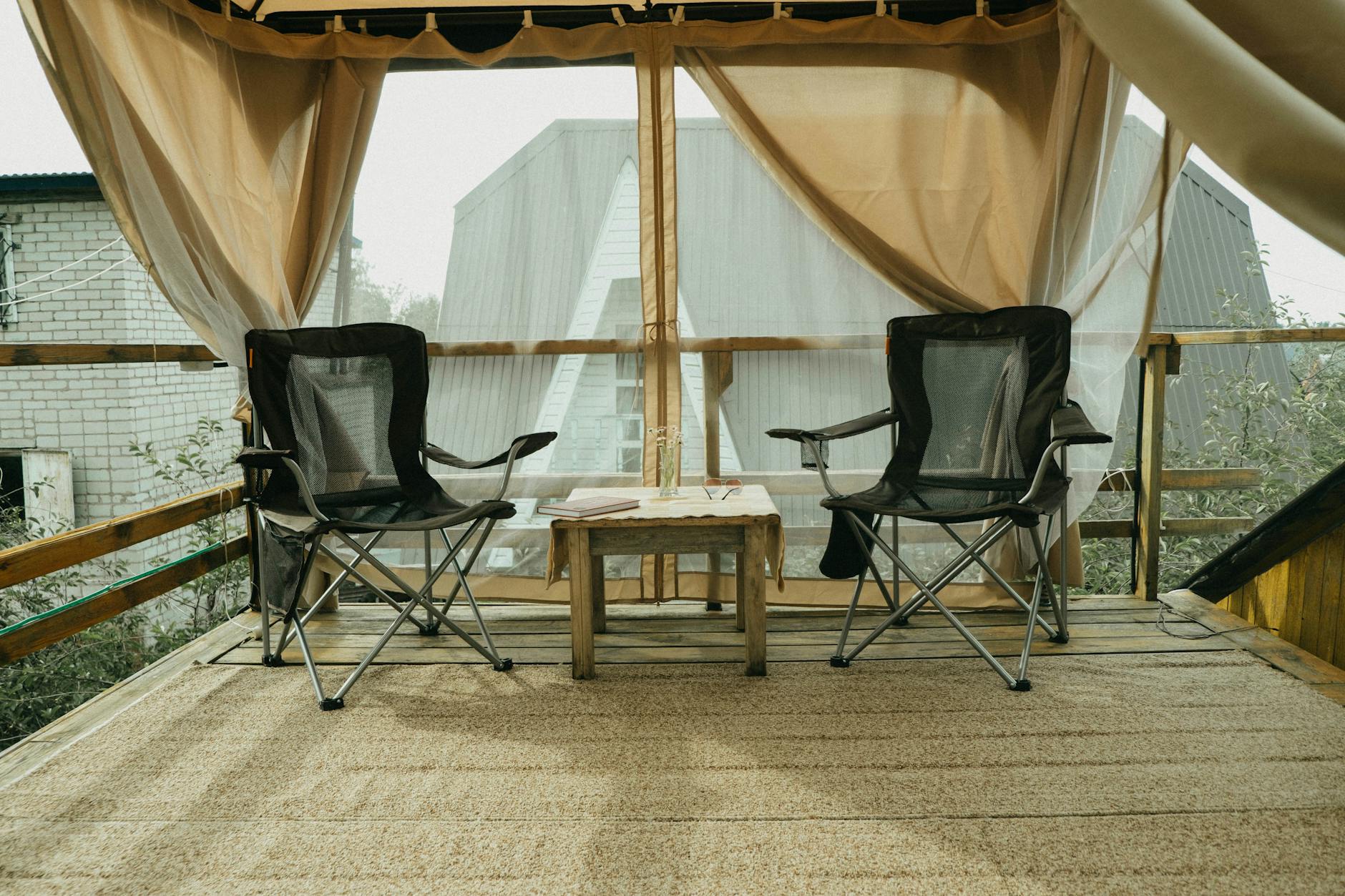 Outdoor patio deck reference with folding chairs and wooden table.