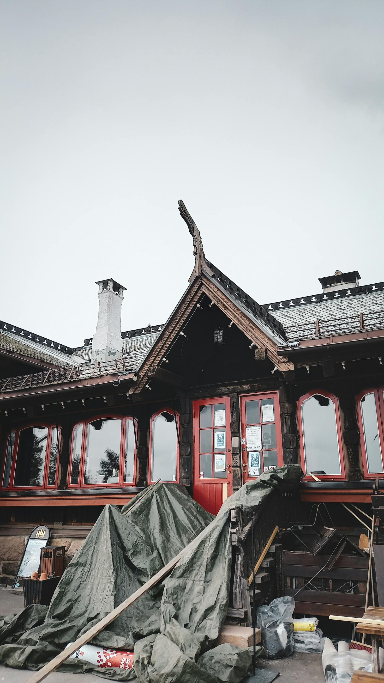 A residential exterior undergoing renovation with visible woodwork.