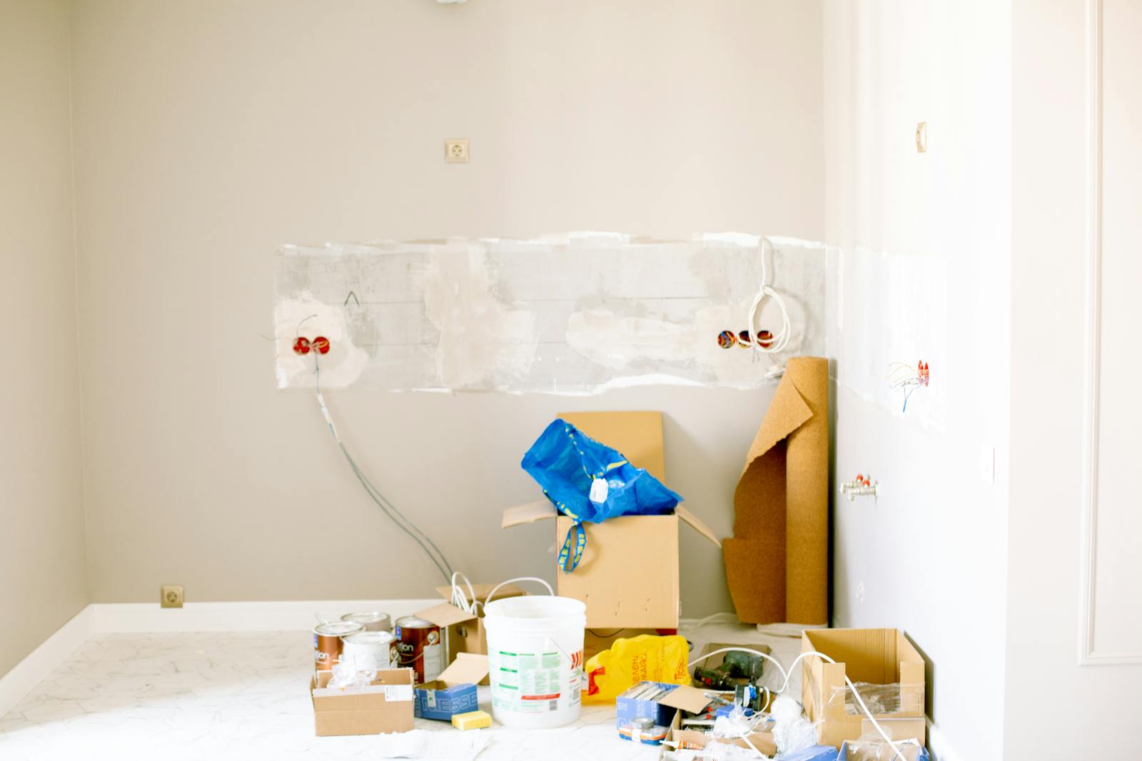 A room being prepared for renovation with tools and supplies.